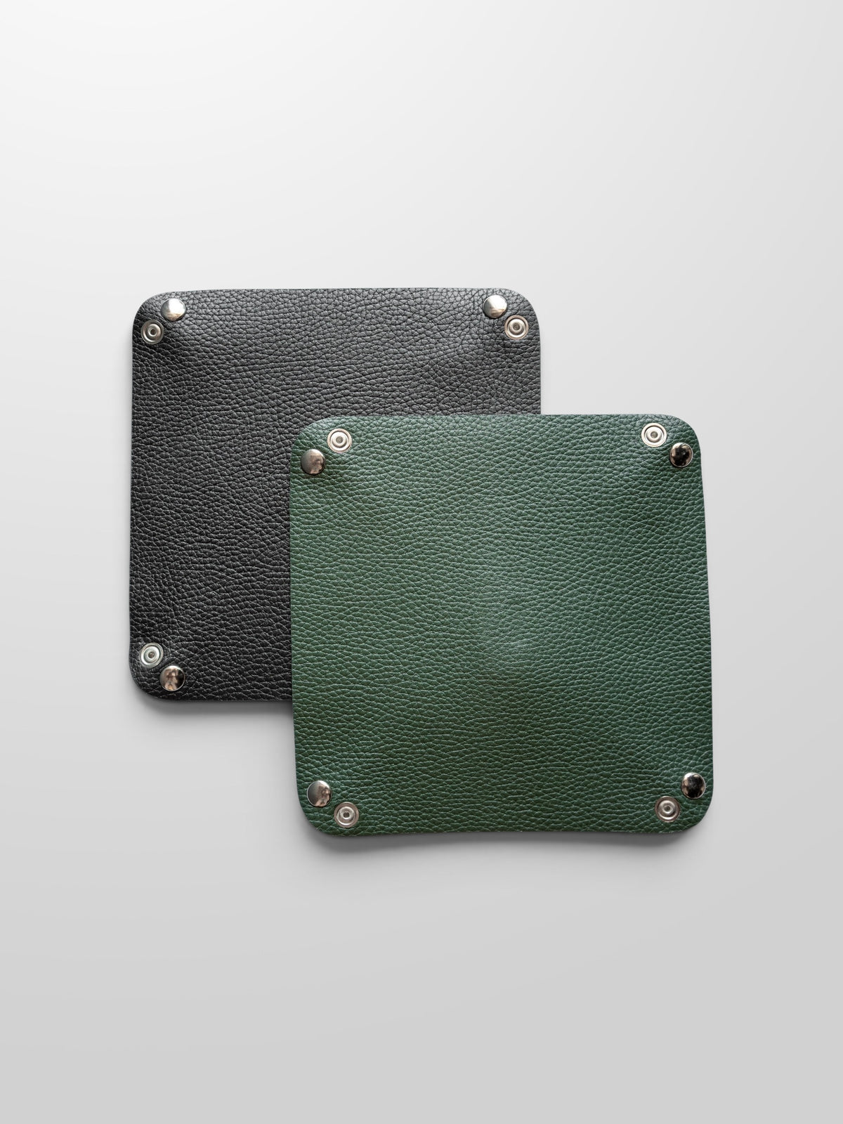 Black and Legacy Green leather valet trays shown side by side