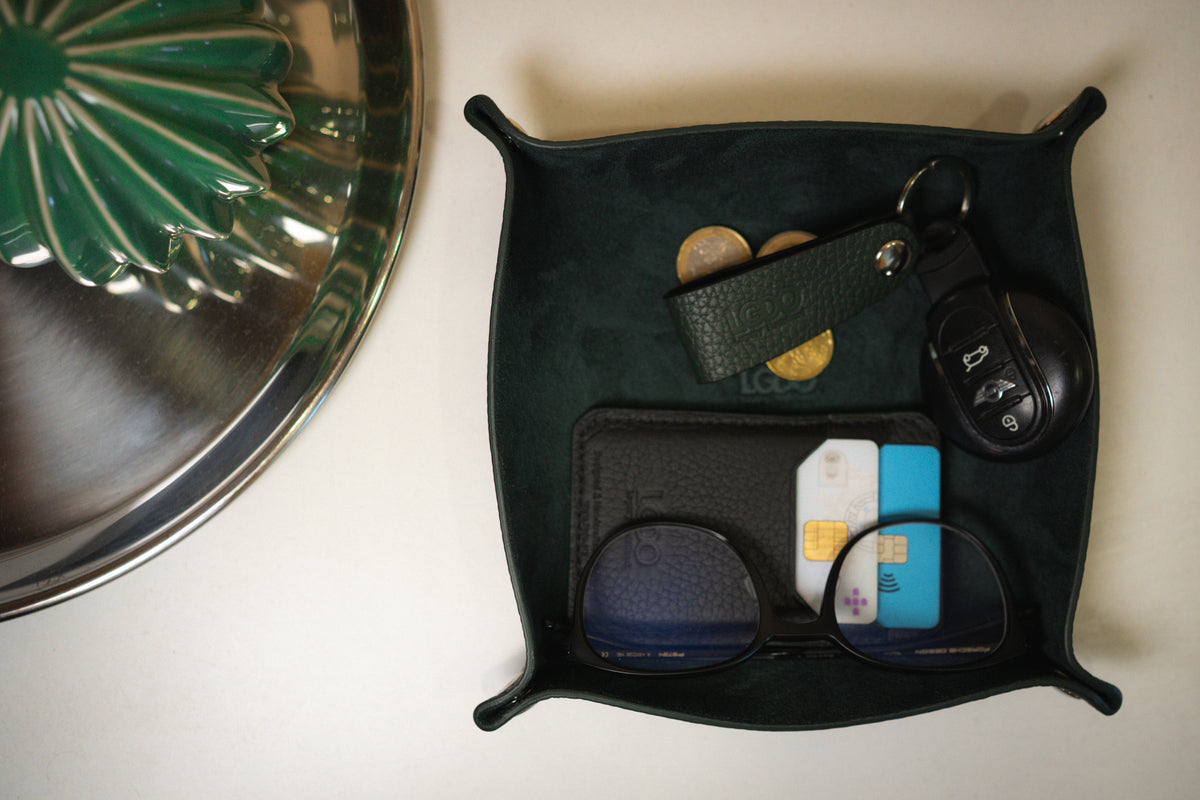 Black leather valet tray and Legacy Green leather key holder shown on a table
