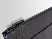 LGDO leather laptop sleeve close-up corner view showing full-grain texture and YKK zipper pull