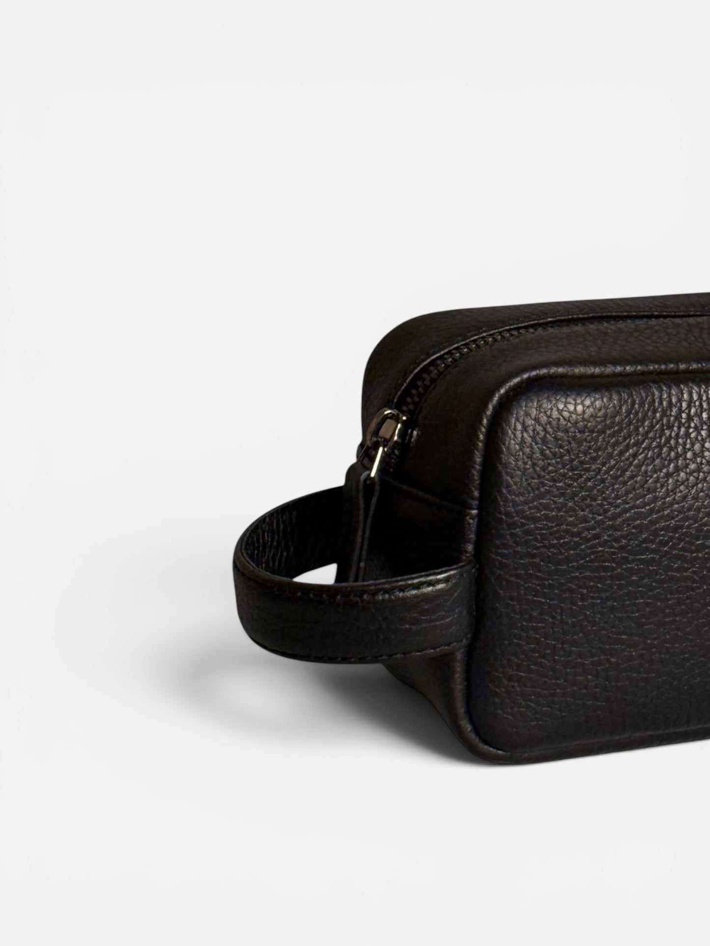 LGDO black leather pouch, three quarter close up showing handle and zipper, full-grain leather, studio background