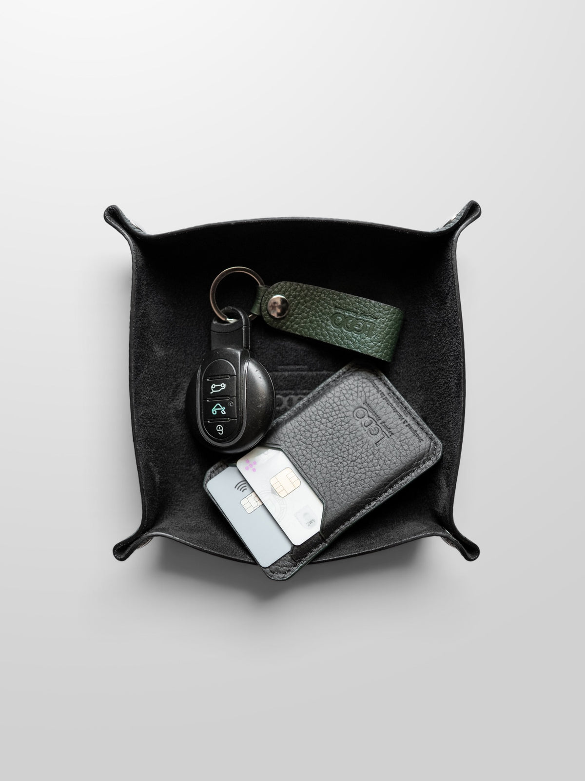 Legacy Green Leather valet tray holding car keys, cards and a leather key holder