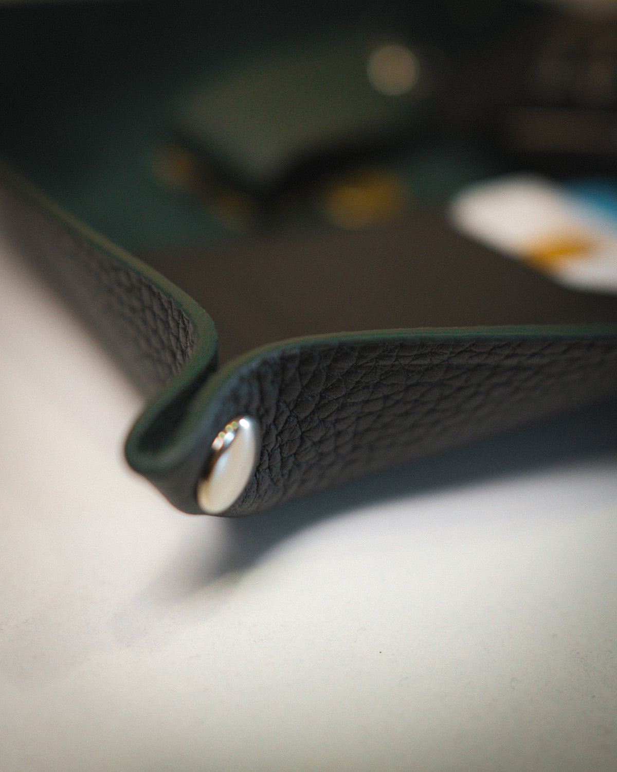 Detail of the corner press stud on a leather valet tray